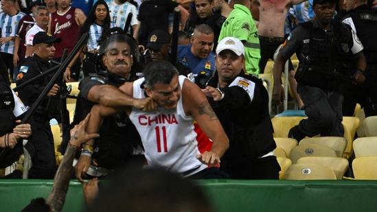 Fans of Argentina clash with Brazilian police before the start of the 2026 FIFA World Cup South American qualification football match between Brazil and Argentina at Maracana Stadium(AFP)