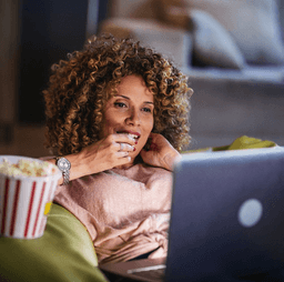 A girl watching movie on a laptop