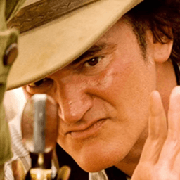 Quentin Tarantino looking at a pistol in Django Unchained